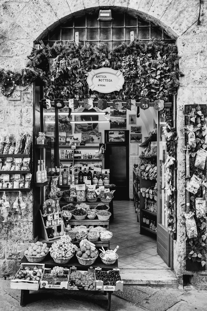 A typical Tuscan gourmet shop in an alley of the medieval city of Siena in central Italy